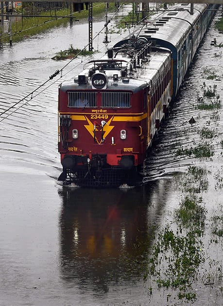 A train wade through a water logged track after heavy rains in Mumbai.