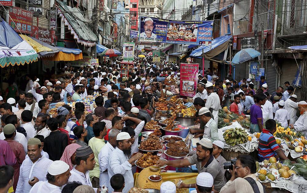 A crowd of Muslim devotees buy food in a market to break the first day of fasting in Dhaka, Bangladesh.