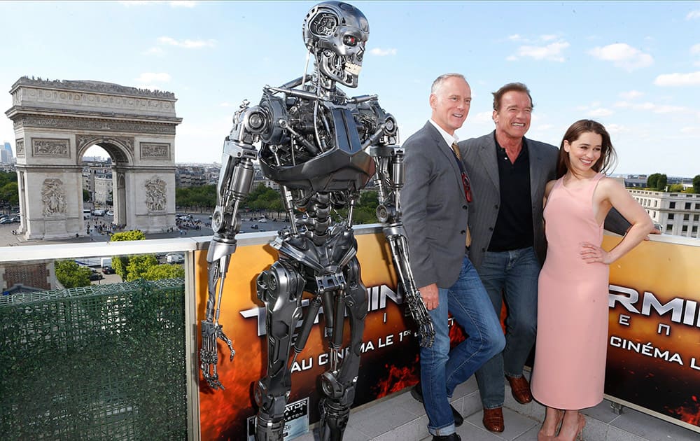 British actress Emilia Clarke, Austrian born actor Arnold Schwarzenegger and US director Alan Taylor, pose for photographers at a preview of the film, Terminator: Genisys, in front of Arch of Triumph, in Paris.
