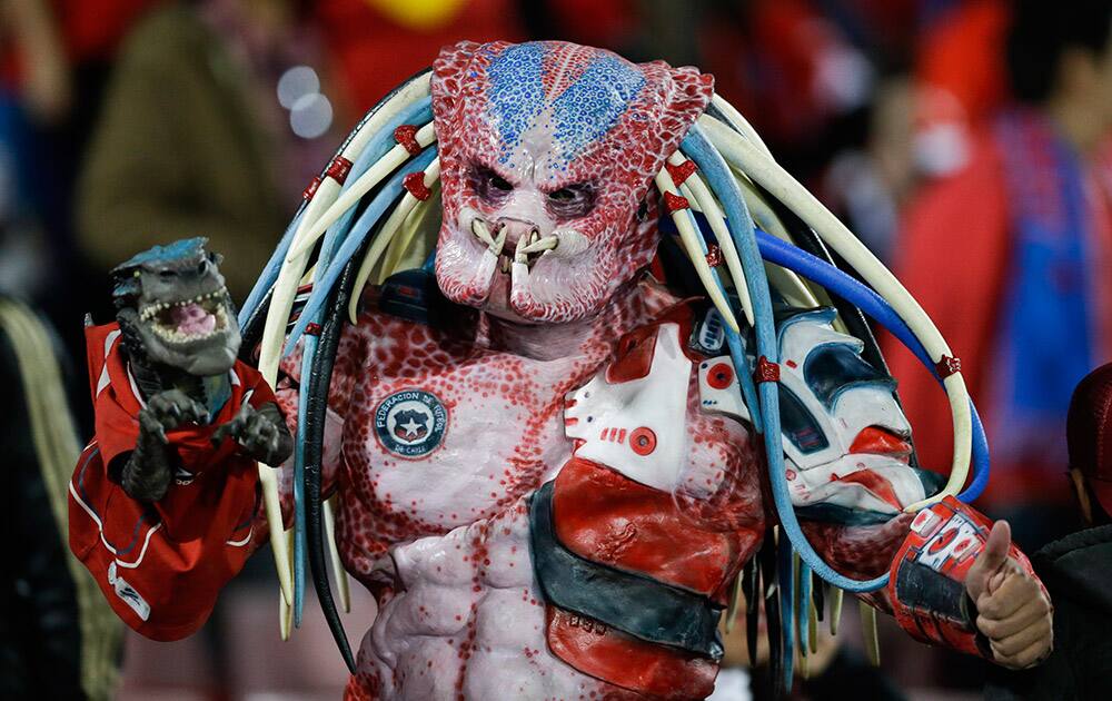 A Chile's fan wearing a costume poses before the start of a Copa America Group A soccer match between Chile and Bolivia at El Nacional stadium in Santiago, Chile.