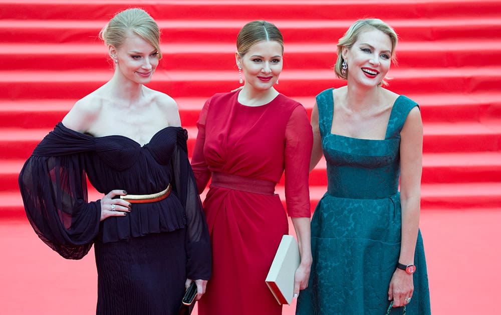 Russian actresses Svetlana Khotchenkova, Maria Kozhevnikova, and actress and director Renata Litvinova, pose for photographers at the opening ceremony of the 37th Moscow International Film Festival in Moscow, Russia.