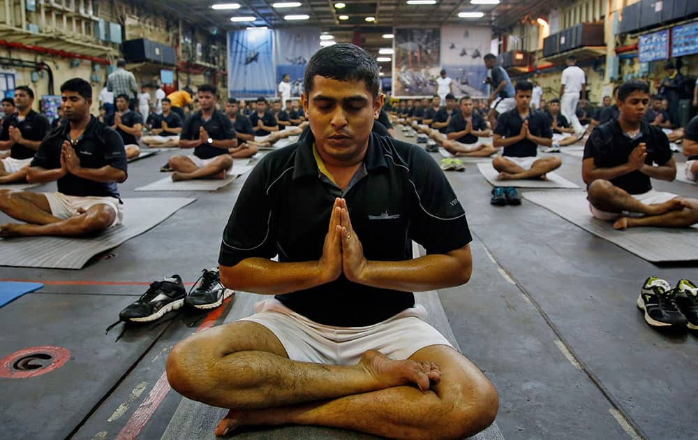 Indian Navy men perform Yoga during rehearsals for the International Yga Day to be marked on June 21, in Mumbai.