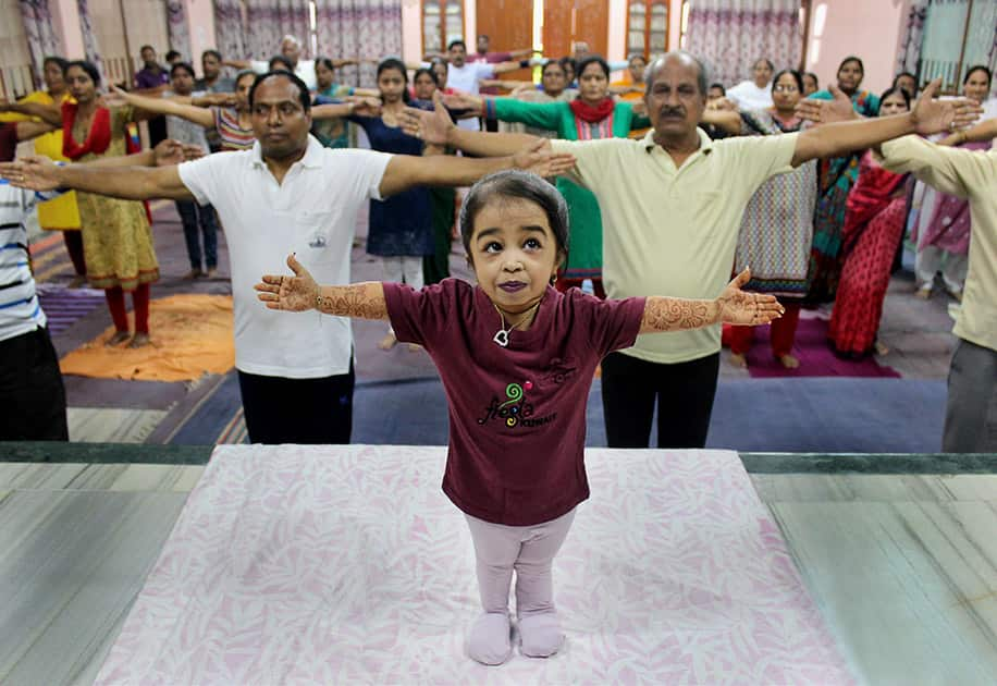 Worlds smallest living woman Jyoti Amge takes part in a Yoga session on the eve of International Yoga Day in Nagpur Maharashtra.