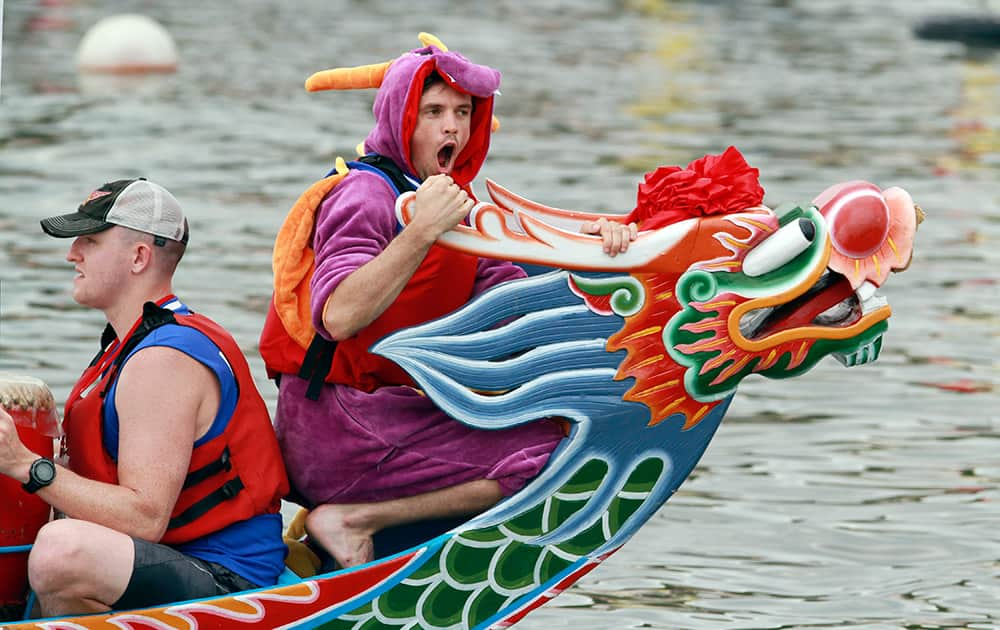 A boat captain wears a dragon costume during a traditional Chinese Dragon Boat race in Taipei, Taiwan.