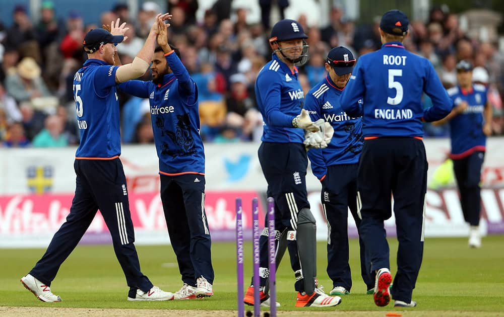 England's Adil Rashid celebrates with his teammates after bowling out New Zealand's Mitchell Santner during the one day international match between England and New Zealand at the Riverside cricket ground, Chester-le-Street, England.