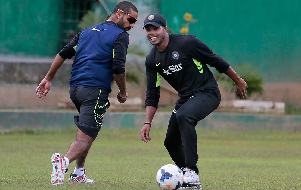 Shikhar Dhawan and Umesh Yadav play with a soccer ball during a practice session ahead of the second one-day international cricket match against Bangladesh in Dhaka, Bangladesh.