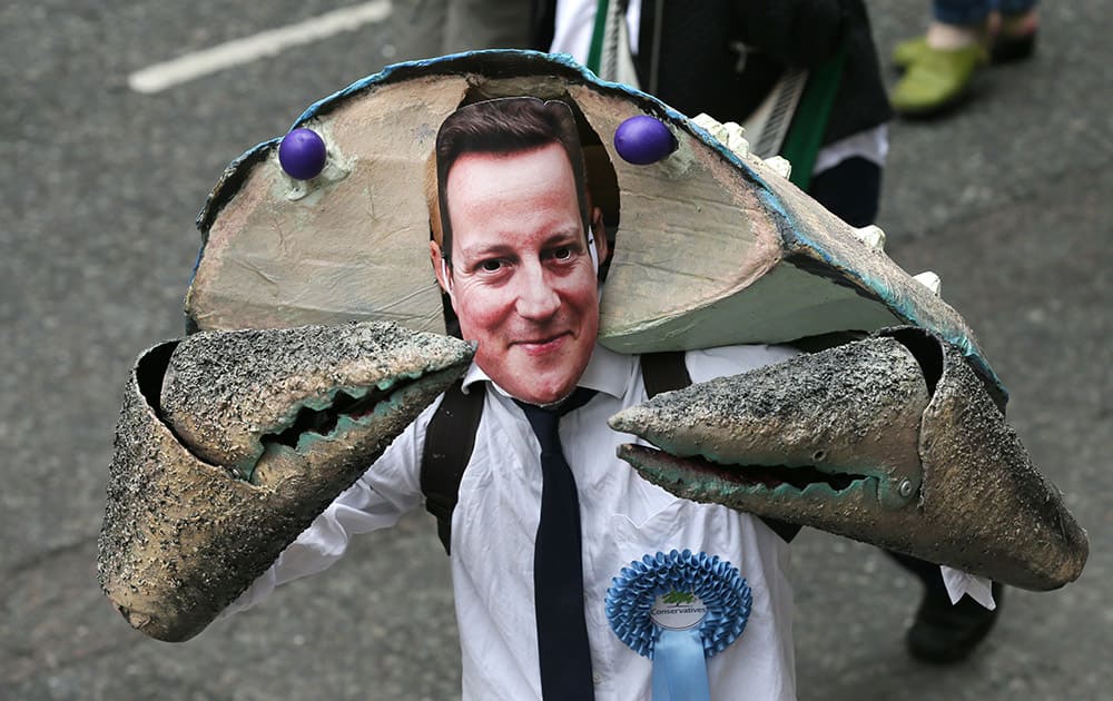 A demonstrator wears a David Cameron mask during a protest against the Conservative Government and it's austerity policies in London.