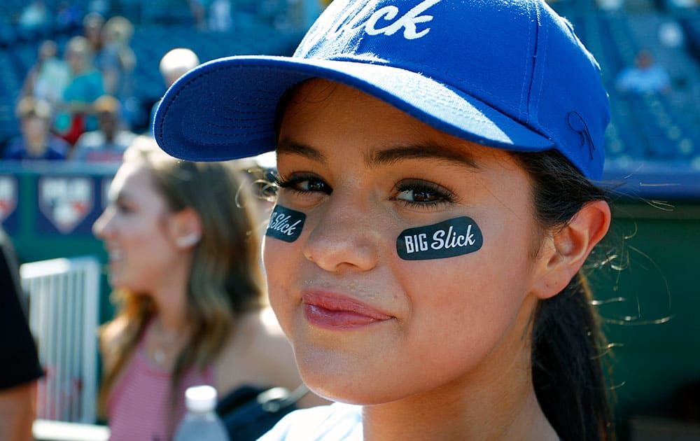 Pop singer Selena Gomez waits for the start of a Big Slick celebrity charity softball game prior to the Royals game at Kauffman Stadium in Kansas City, Mo.