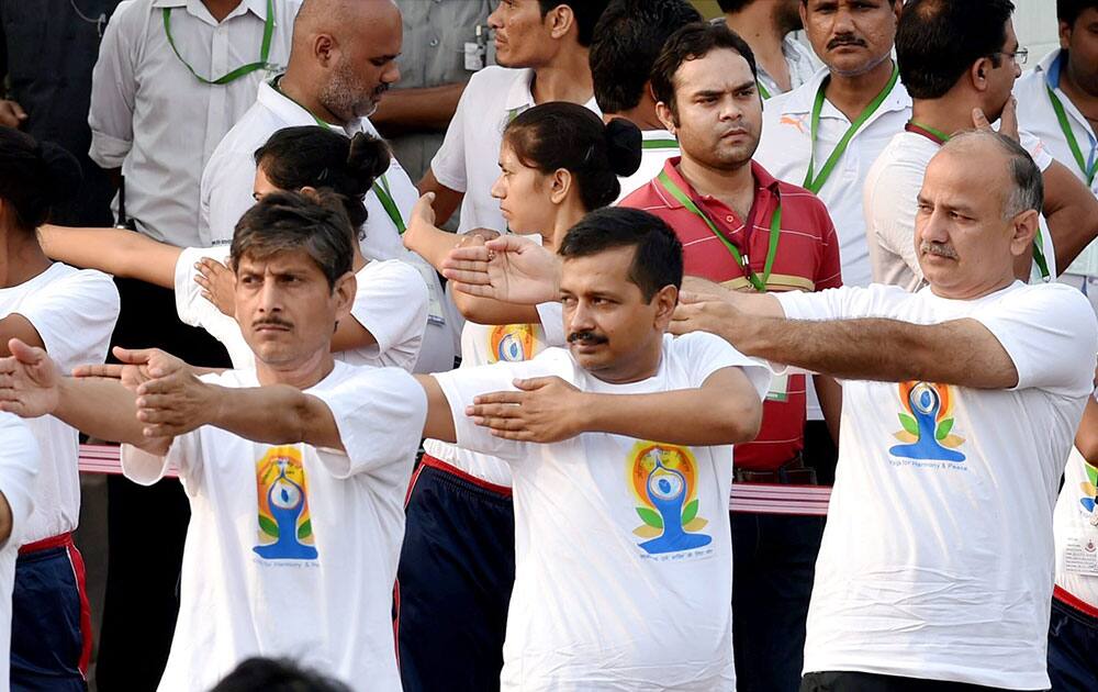 Delhi CM Arvind Kejriwal and Dy chief Minister Manish Sisodia participate in a mass yoga session along with other yoga practitioners to mark the International Day of Yoga 2015 in New Delhi.