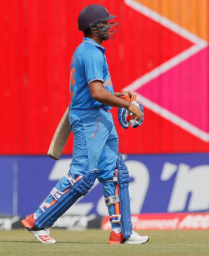 India’s Rohit Sharma walks back to the pavilion after his dismissal by Bangladesh’s Mustafizur Rahman during their second one-day international cricket match in Dhaka, Bangladesh.