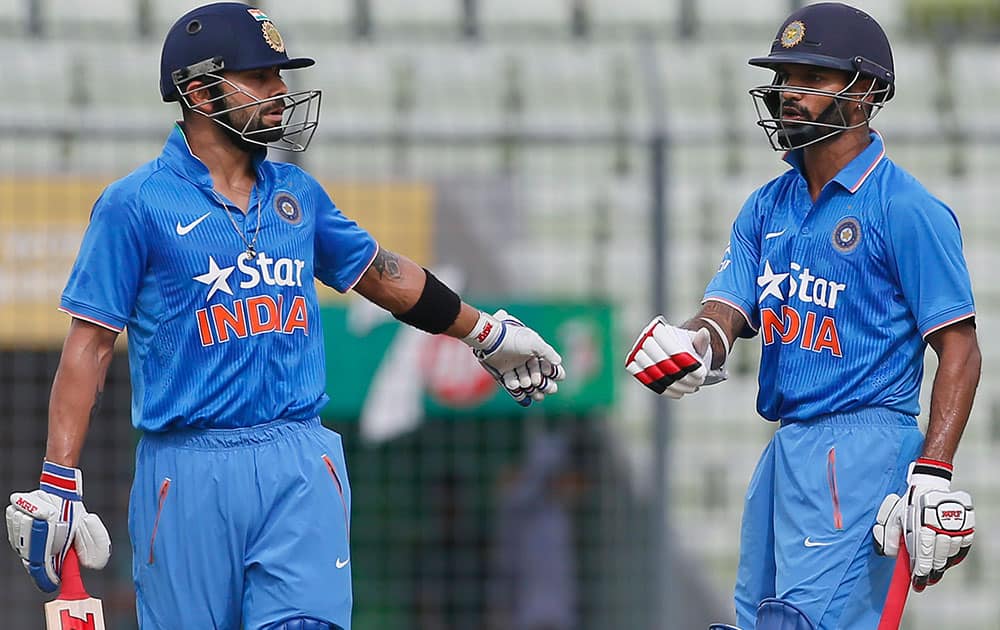 India’s Shikhar Dhawan, right, and teammate Virat Kohli celebrate a boundary shot during the second one-day international cricket match against Bangladesh in Dhaka, Bangladesh.