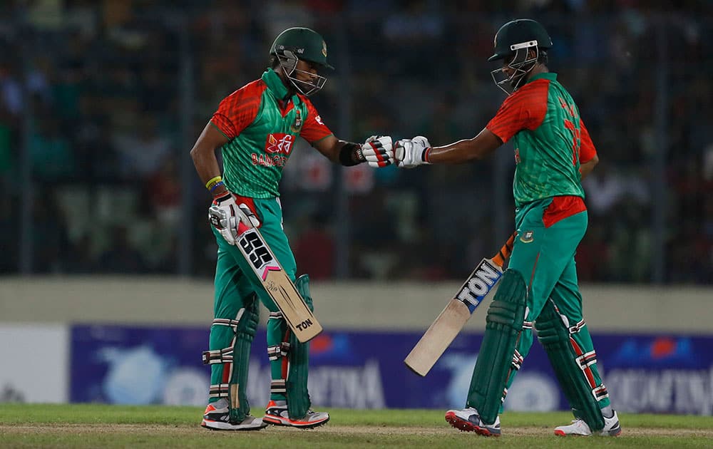 Bangladesh’s Shakib Al Hasan, right, and Sabbir Rahman celebrate a boundary shot during their second one-day international cricket match against India in Dhaka, Bangladesh.