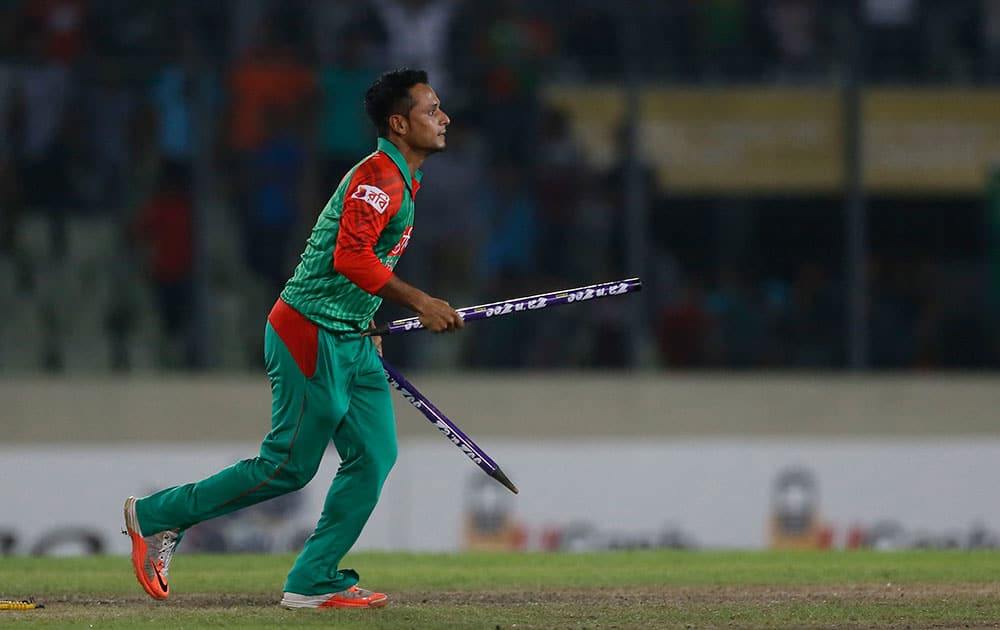 Bangladesh’s Arafat Sunny walks with wickets after the win over India during their second one-day international cricket match in Dhaka, Bangladesh.