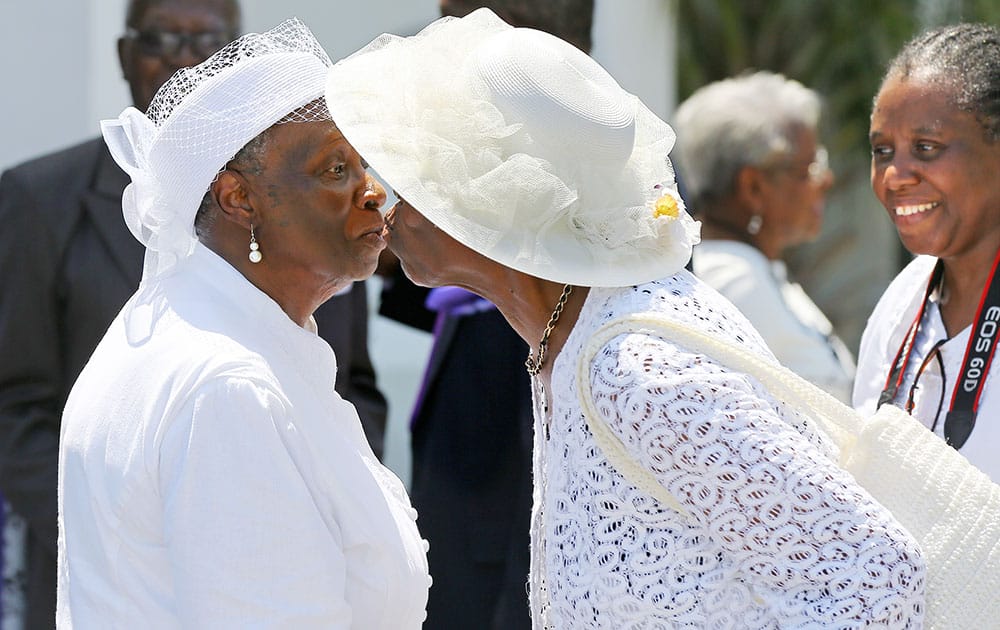 Church members exchange a kiss as they leave a Sunday worship service at the Emanuel A.M.E. Church, four days after the mass shooting that claimed the lives of it's pastor and eight others, in Charleston, S.C. 