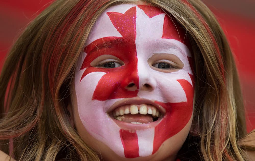 A young Canadian fan cheers as Canada and Switzerland warm up before a FIFA Women's World Cup round of 16 soccer game in Vancouver, British Columbia.