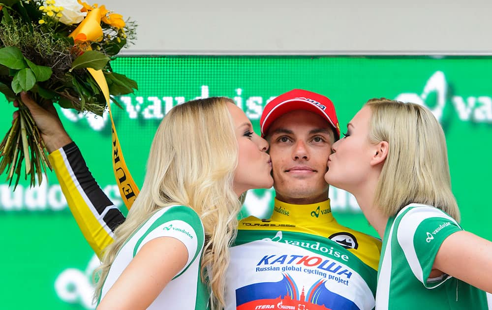 Winner Simon Spilak from Slovenia of team Katusha, center, is kissed by two hostesses on the podium after the 9th and last stage, a 38,4 km race against the clock, from Bern to Bern, at the 79th Tour de Suisse UCI ProTour cycling race, in Bern, Switzerland.