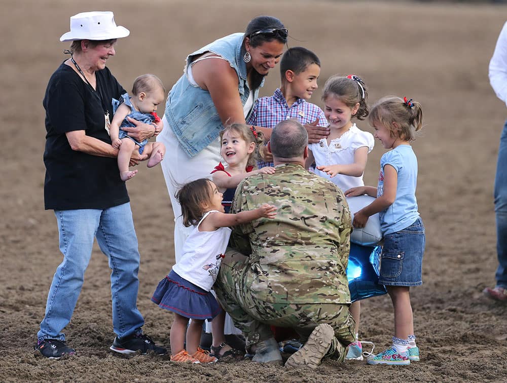 Nevada Army National Guard Chief Warrant Officer Glen Spadin surprises his family in front of nearly 9,000 people at the Reno Rodeo in Reno, Nev. Spadin returned after a year in Afghanistan to surprise his six children.