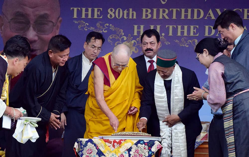 Tibetan spiritual leader the Dalai Lama cuts a cake with Chief minister of Himachal Pradesh Virbhadra Singh to celebrate his 80th birthday at Tsuglagkhang Temple in Mcleodganj, Dharamshala.