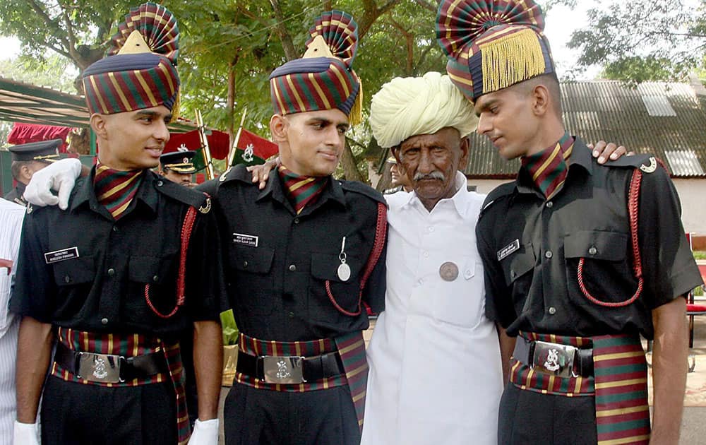 Three cadets sharing joy with their proud grandfather after the passing out parade of recruits of the Pioneer Corps at Parade Ground in Bengaluru.