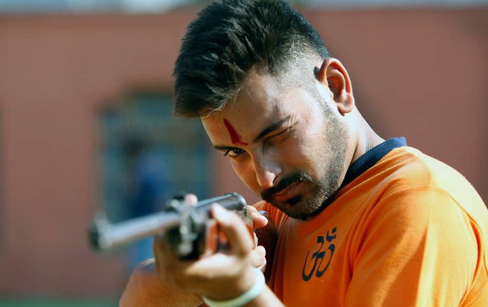 An Indian man practices shooting during a self-defense training camp, in Akhoor, 30 kilometers (19 miles) from Jammu, India.  The camp was organized by the Vishwa Hindu Parishad, a Hindu nationalist group, for children and men living near India Pakistan border towns and militancy affected areas. 