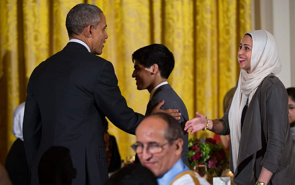 President Barack Obama, left, greets guests after delivering remarks during the annual Iftar dinner, celebrating the Muslim holy month of Ramadan, in the East Room of the White House.