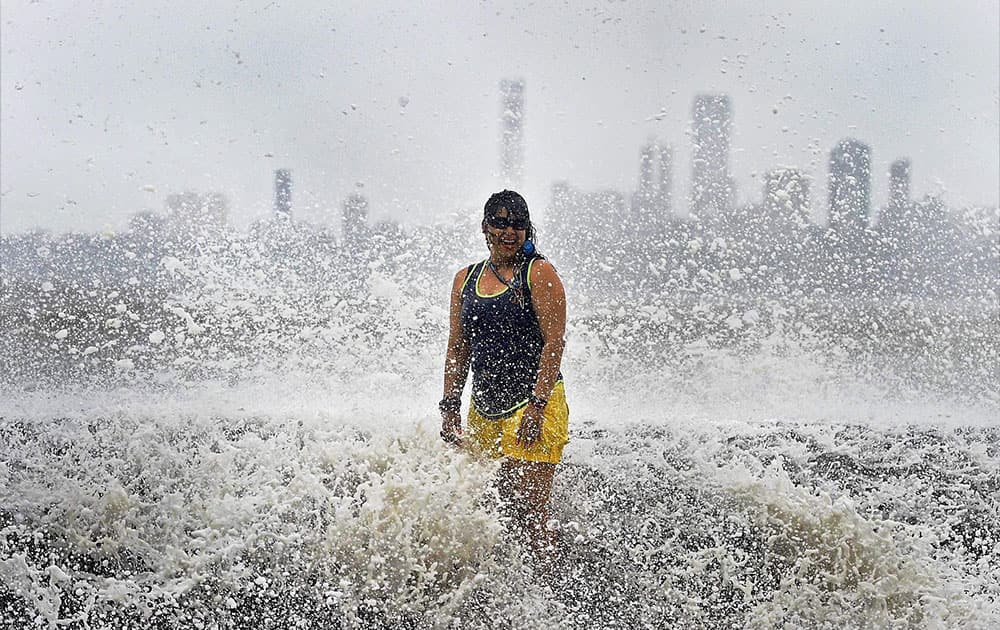 A girl enjoys high tide at the Marine drive in Mumbai.