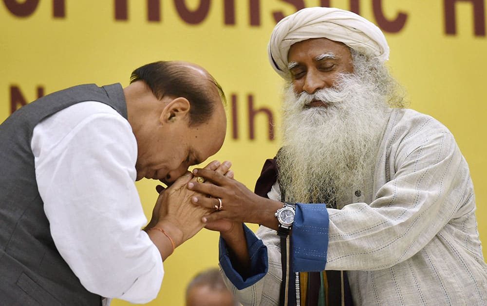 Home Minister Rajnath Singh seeks blessings of Sadguru Jaggi Vasudev during the 2nd day of International Conference on Yoga in New Delhi.