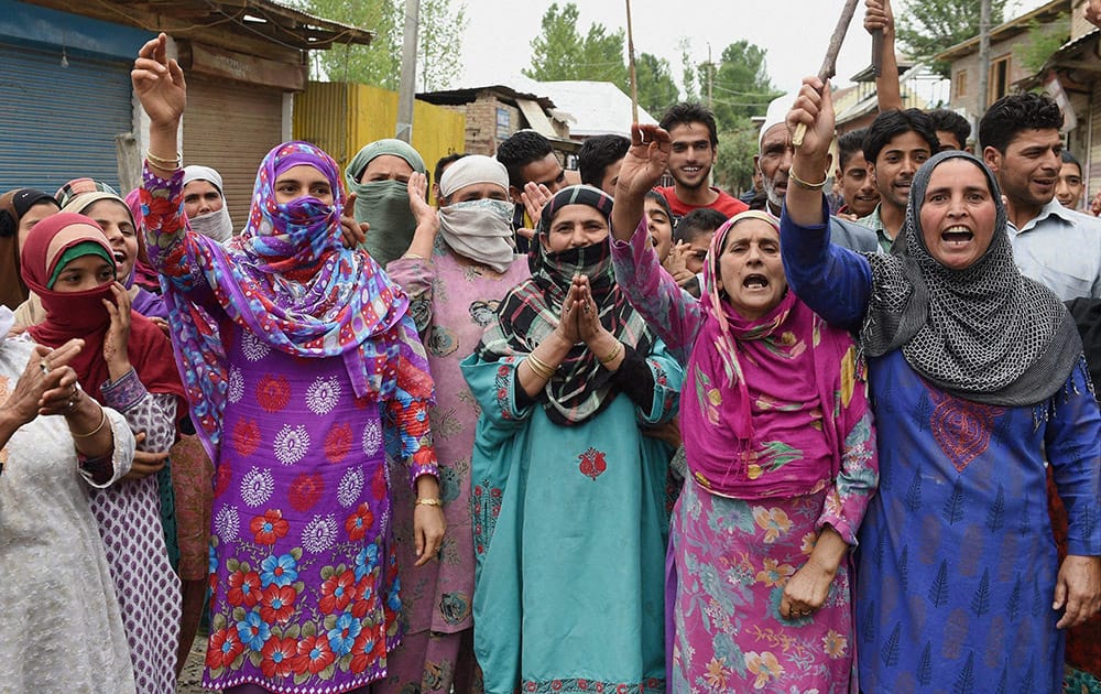 People shout slogans and block a road during a protest against shortage of water and pesky power cuts at Narakara in Budgam district of central Kashmir.