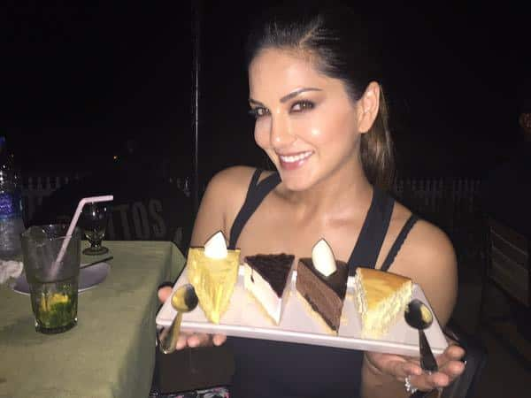 This is how @hitendra1480 tortures me. He steals my cakes all the time. Lol love you my food FBI. Twitter@SunnyLeone