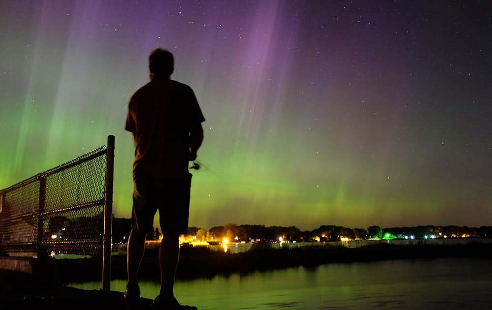 Wade Kitner looks at the northern lights as he fishes in Ventura, Iowa. Federal forecasters said the Northern Lights may be able to be seen Tuesday night as far south as Iowa or Pennsylvania because of a severe solar storm that hit the Earth on Monday and pushes auroras to places where more people can possibly see them.