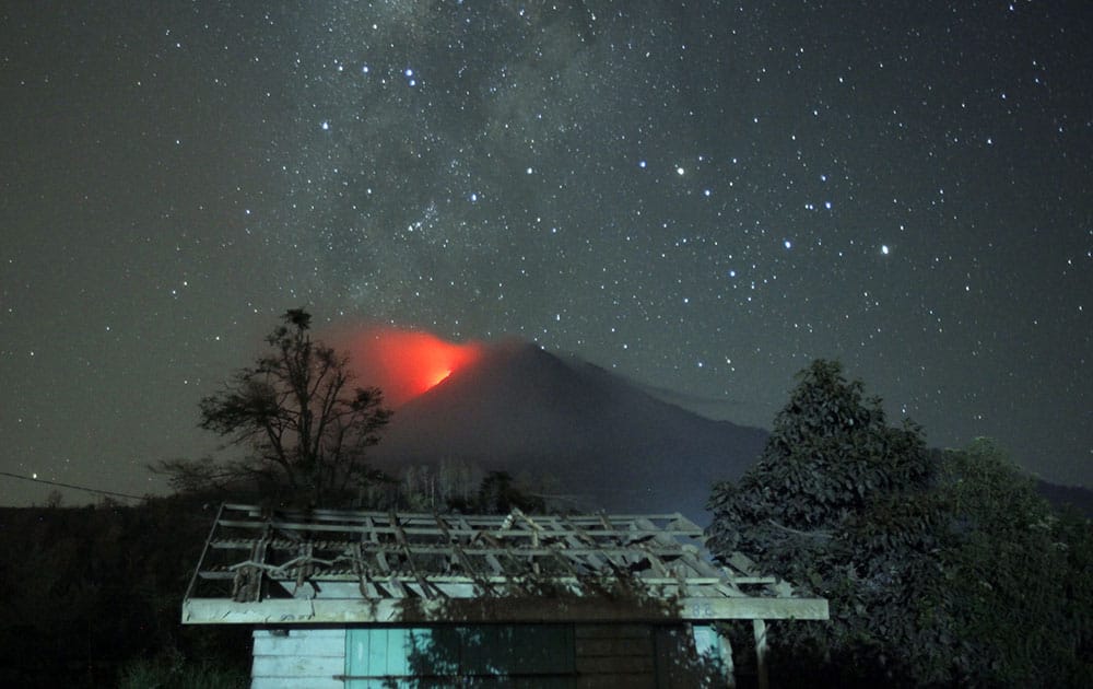 Hot lava flows from the crater of Mount Sinabung as seen from Sigarang Garang, North Sumatra, Indonesia.