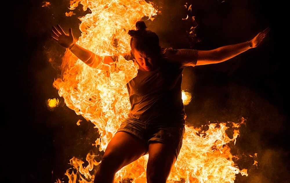A reveler jumps over a bonfire during the night of San Juan in Alcobendas near Madrid, Spain.