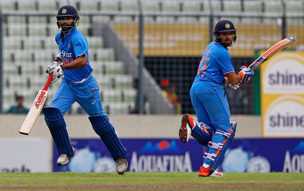 Shikhar Dhawan and Rohit Sharma run between the wickets during their third one-day international cricket match against Bangladesh in Dhaka.