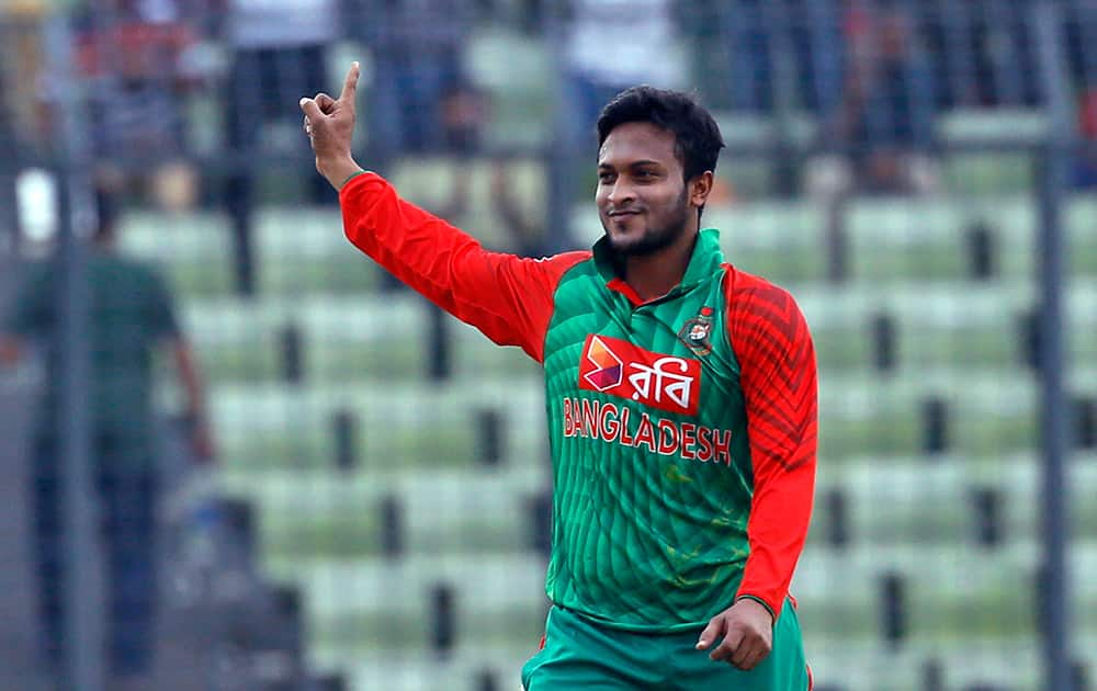 Shakib Al Hasan celebrates the dismissal of Virat Kohli during their third one-day international cricket match in Dhaka.