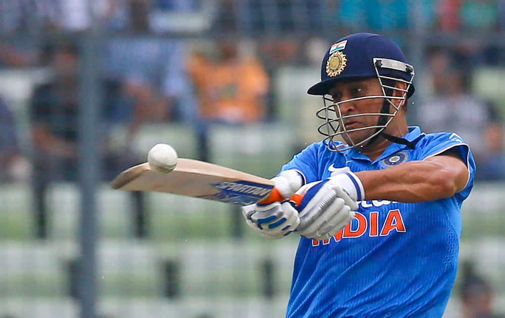 M S Dhoni plays a shot during the third one-day international cricket match against Bangladesh in Dhaka.