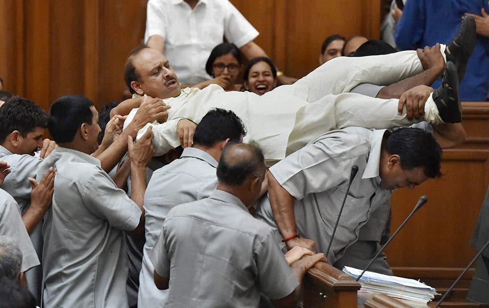 BJP leader in Delhi Assembly Vijender Gupta is taken out of the Assembly by marshals after a protest on the second day of the monsoon session in New Delhi.