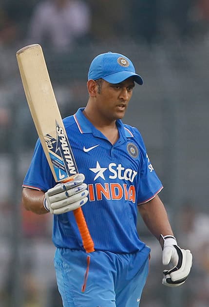 M S Dhoni acknowledges the crowd after scoring fifty runs during the third one-day international cricket match against Bangladesh in Dhaka.