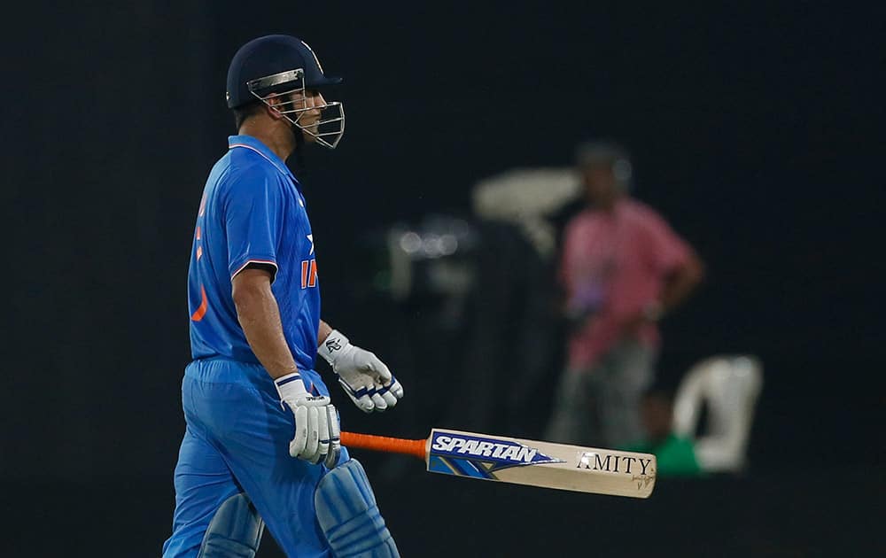 M S Dhoni walks back to the pavilion after his dismissal by Bangladesh’s captain Mashrafe Mortaza during their third one-day international cricket match in Dhaka.