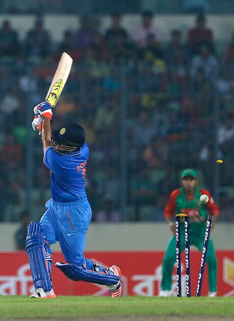 Suresh Raina is bowled out by Bangladesh’s Mustafizur Rahman during their third one-day international cricket match in Dhaka.