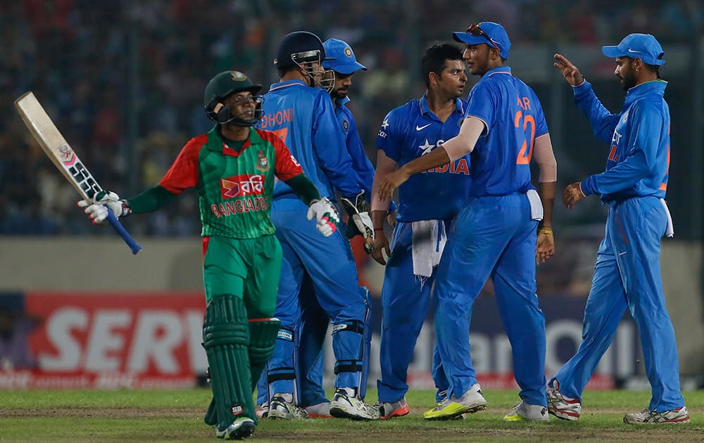 Suresh Raina celebrate with his teammates after the dismissal of Bangladesh’s Mushfiqur Rahim during their third one-day international cricket match in Dhaka.