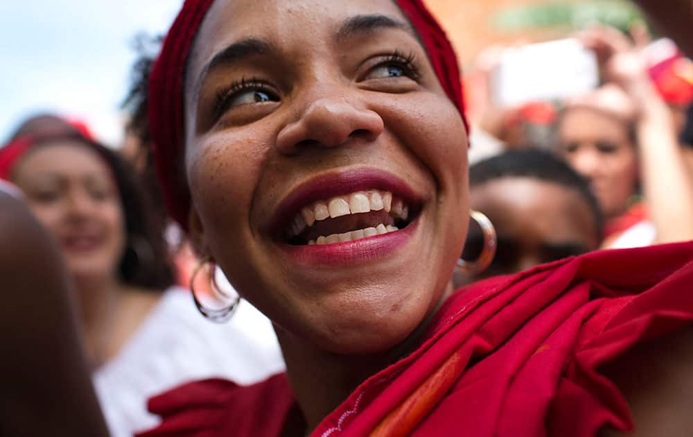 A woman smiles as she dances during the San Juan festivities in Curiepe, Miranda State, Venezuela.