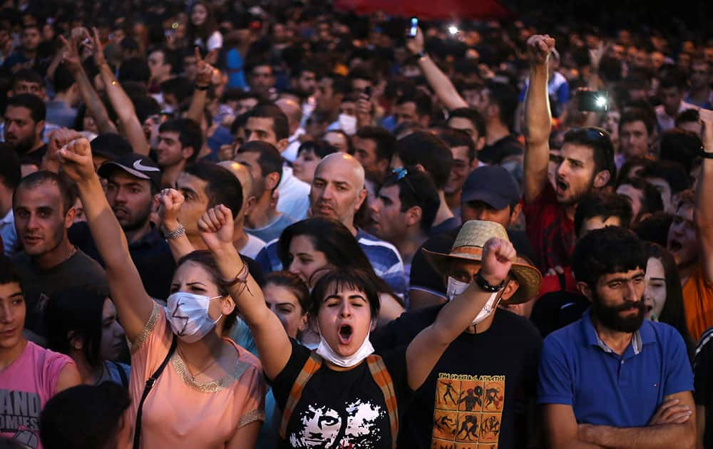 Armenian protesters shout anti-government slogans during a protest rally against a hike in electricity prices in Yerevan, Armenia.