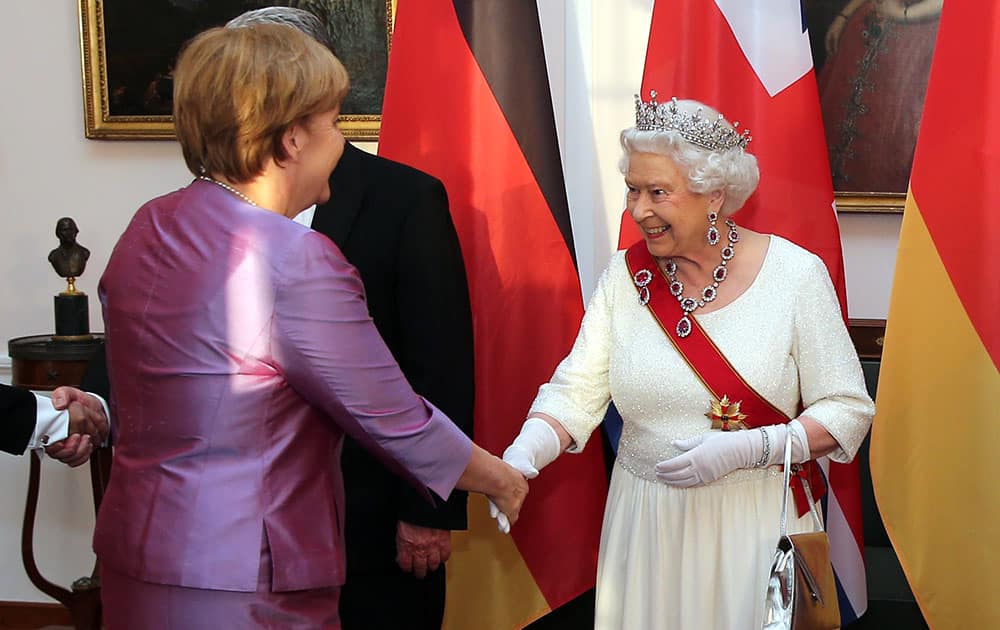 Britain's Queen Elizabeth II, right, shakes hand with German Chancellor Angela Merkel, left, prior to a State Banquet hosted by President Gauck in Bellevue Palace in Berlin.