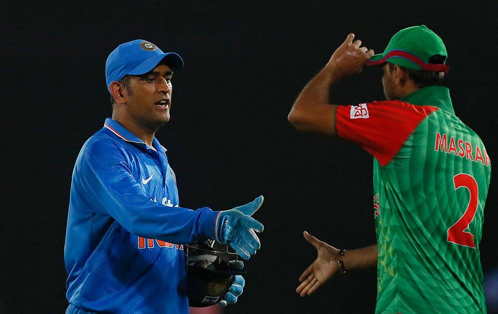 India’s captain M S Dhoni, left, greets Bangladesh’s captain Mashrafe Mortaza after winning their third one-day international cricket match in Dhaka, Bangladesh.