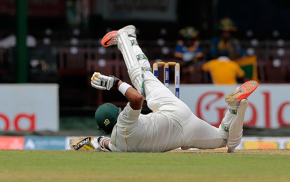 Pakistan's Azhar Ali slips on a wicket during the first day of the second test cricket match against Sri Lanka in Colombo, Sri Lanka.