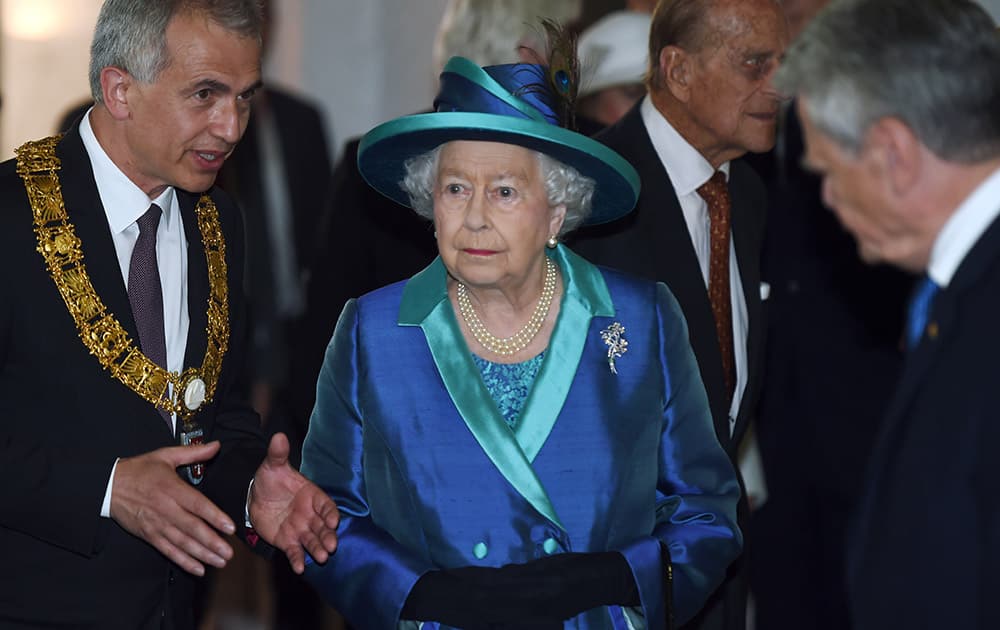 Britain's Queen Elizabeth II, center, and Prince Philip, Duke of Edinburgh, rear second right, and Frankfurt's Mayor Peter Feldmann, left, visit the St. Paul's Church in Frankfurt, central Germany.