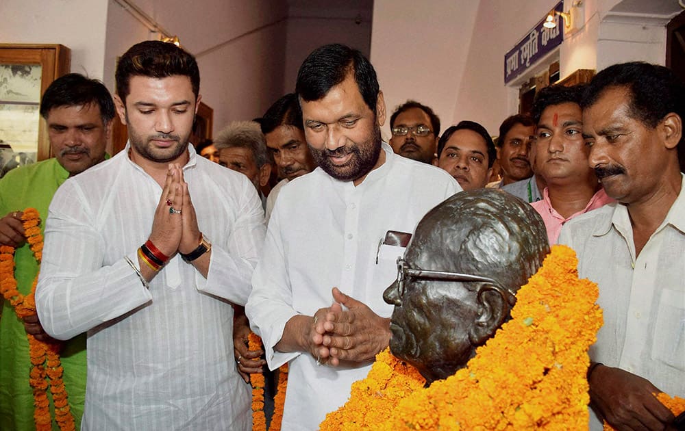 Union Food Minister Ram Vilas Paswan with his son and LJP MP Chirag Paswan pay tributes to a statue of Jai Prakash Narayan on the ocassion of completion of 40 years of the Emergency, in Patna.