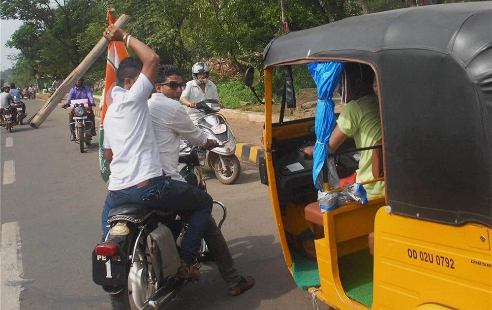 Congress workers threaten an auto driver during a 12 hour Odisha bandh in Bubaneshwar.