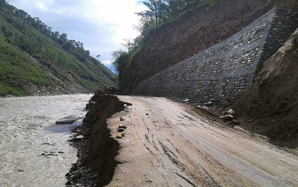 A part of Kedarnath National Highway washed away after Mandakini river went overflow due to heavy rainfall in Kedarnath.