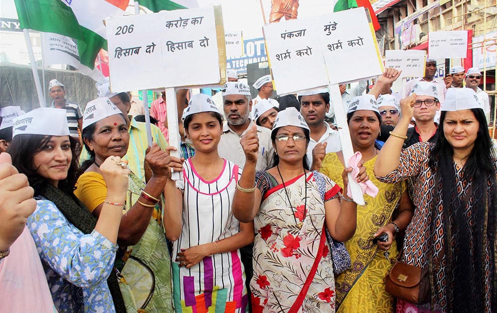 AAP workers hold placards and shout slogans during their protest against Maharashtra Rural Development Minister Pankaja Munde demanding her immediate resignation in Nagpur.